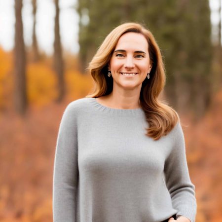 woman with long brown hair and green eyes, dressed casually, on an autumn forest backgroup, she is founder and CEO of Chatter Labs